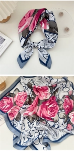 Detail of silk-feel scarf with floral rose pattern and elegant French-style packaging props