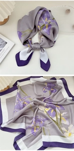 Detail of floral silk scarf featuring light purple irises on a smooth satin finish