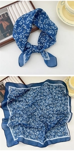 Detail of navy blue cotton linen square scarf with white leaf patterns and floral print