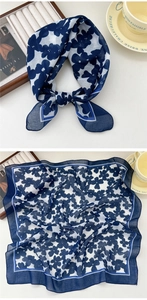 Detail of floral linen silk scarf showing elegant navy blue pattern and bow styling