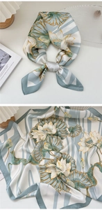 Detailed view of silk scarf with elegant lotus print and gray-green stripes