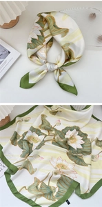 Detailed view of floral silk scarf featuring lotus print and silk luster finish