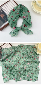Detail of green floral linen square scarf showing fabric texture and print quality