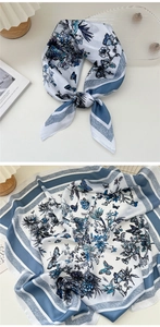 Detailed view of floral silk scarf featuring blue butterfly patterns and striped borders