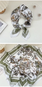Detail of silk square scarf featuring olive green borders and floral butterfly prints