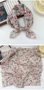 Detail of floral cotton linen neck scarf with elegant red flower patterns and fine stitching