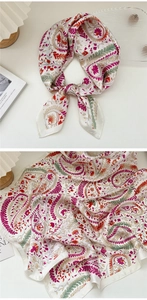 Detail view of floral paisley pattern silk scarf with hand-rolled edges and satin finish