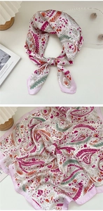 Detail of pink floral paisley silk scarf with elegant pattern and soft fabric texture