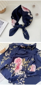 Detail showing navy blue silk scarf with floral rose pattern and rolled hem finish