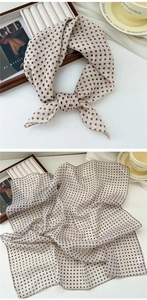 Detail of light beige cotton linen scarf with dark brown polka dots and fine stitching