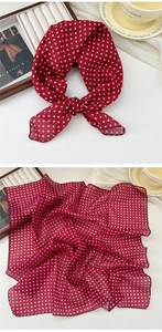 Detail of soft dark red scarf with white polka dots and high-quality stitched edges