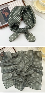 Detail of dark green polka dot cotton linen scarf showing texture and knot styling