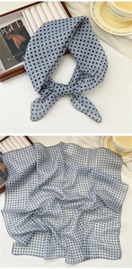 Detail of light blue polka dot cotton linen scarf with fine hemmed edges and soft texture