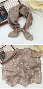Detail of brown cotton linen square scarf with paisley pattern on wooden tray