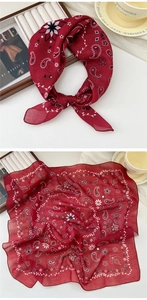 Detail of soft red cotton linen square scarf with classic paisley print and hemmed edges