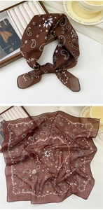 Detail of coffee brown paisley linen scarf with vintage pattern and soft texture