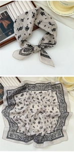Detail of soft linen-cotton square scarf with black floral and paisley print patterns