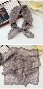 Close-up of soft grey-purple linen-cotton scarf with white paisley and floral patterns