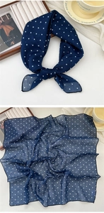 Detail of navy blue polka dot cotton linen scarf showing texture and knot styling