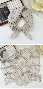 Detail of cream cotton linen scarf with black polka dots showing soft fabric texture