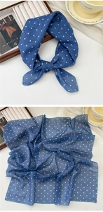 Close-up of lightweight navy blue polka dot cotton linen neckerchief with soft texture