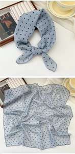 Close-up of light blue polka dot cotton linen neckerchief with soft breathable texture