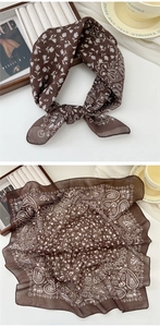 Close-up of semi-transparent dark brown cotton linen scarf with white paisley floral pattern
