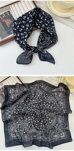Detail of dark blue paisley cotton linen scarf featuring moon and floral prints
