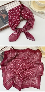 Macro detail of burgundy paisley cotton linen scarf showing soft texture and rolled edges