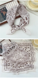 Detail of cotton linen scarf showing intricate brown paisley patterns and soft texture