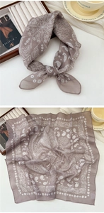 Detail of greyish-purple paisley square scarf with delicate rolled hem and floral pattern