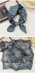 Detail of navy cotton linen square scarf with white paisley pattern on wooden tray