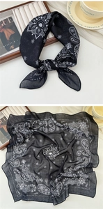 Close-up of black cotton-linen scarf with white paisley patterns and soft hemmed edges
