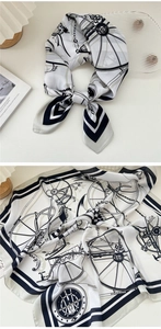 Dettaglio del motivo vintage con carrozza e catene su un foulard di seta bianco e nero