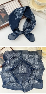 Detail of navy blue paisley cotton linen scarf with soft texture and white floral patterns