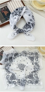 Close-up of white cotton linen square scarf featuring black paisley mandala patterns
