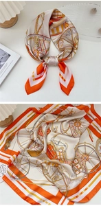 Vista dettagliata di un foulard di seta arancione con motivi classici di carrozze