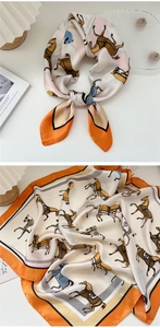 Dettaglio di un foulard in seta con motivi equestri di cavalli nei toni arancio e beige