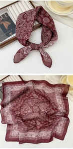 Detail of burgundy paisley cotton linen scarf with soft texture and rolled edges