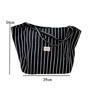 Detail view of striped canvas tote bag showing Bonogeed label and 39cm width size