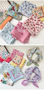 Detail of floral cotton linen square scarves showing soft texture and pastel prints
