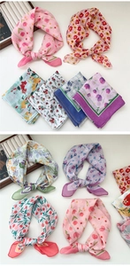 Close-up of assorted floral cotton linen scarves with tulip and vintage patterns