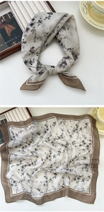 Detail of floral chiffon square scarf with brown border and elegant knot styling