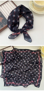 Detail of floral printed square scarf showing delicate fabric texture and pattern