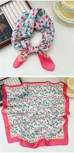 Detail of soft floral cotton scarf featuring red tulips and elegant pink border trim