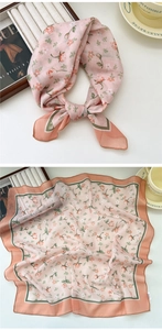 Detail view of floral cotton neck scarf with rose pattern and striped border trim
