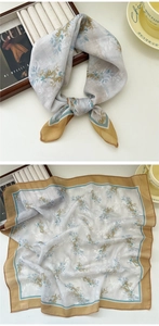 Detail of floral chiffon square scarf with delicate rolled edges on a stylish desk