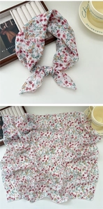 Detail of white floral cotton linen scarf with soft pink flowers and Vogue magazine