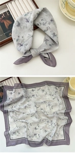 Detail view of a floral square scarf in lavender with delicate purple hem and chic styling