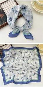 Detail of floral plaid square scarf with silk texture and elegant blue border finish